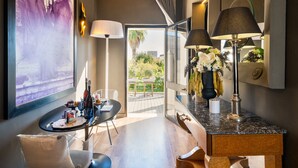 A modern hotel room with a dining area, a large window with a view, and a decorative vase with flowers. - Pet-Friendly Holiday Home 'Maison Boutique At Uno' with Pool & Wi-Fi (san pietro in lama)