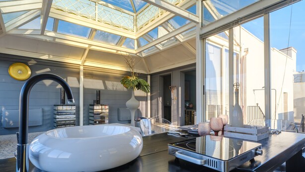A modern kitchen with a large white sink, a built-in stove, and a glass-top dining table. - Pet-Friendly Holiday Home 'Maison Boutique At Uno' with Pool & Wi-Fi (san pietro in lama)