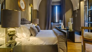 A modern hotel room with a large bed, a glass side table, a lamp, and a view of the city through a window. - Pet-Friendly Holiday Home 'Maison Boutique At Uno' with Pool & Wi-Fi (san pietro in lama)