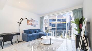 Deluxe Apartment | Living room | 55-inch Smart TV with cable channels, TV, Netflix