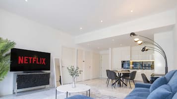 Deluxe Apartment | Living room | 55-inch Smart TV with cable channels, TV, Netflix