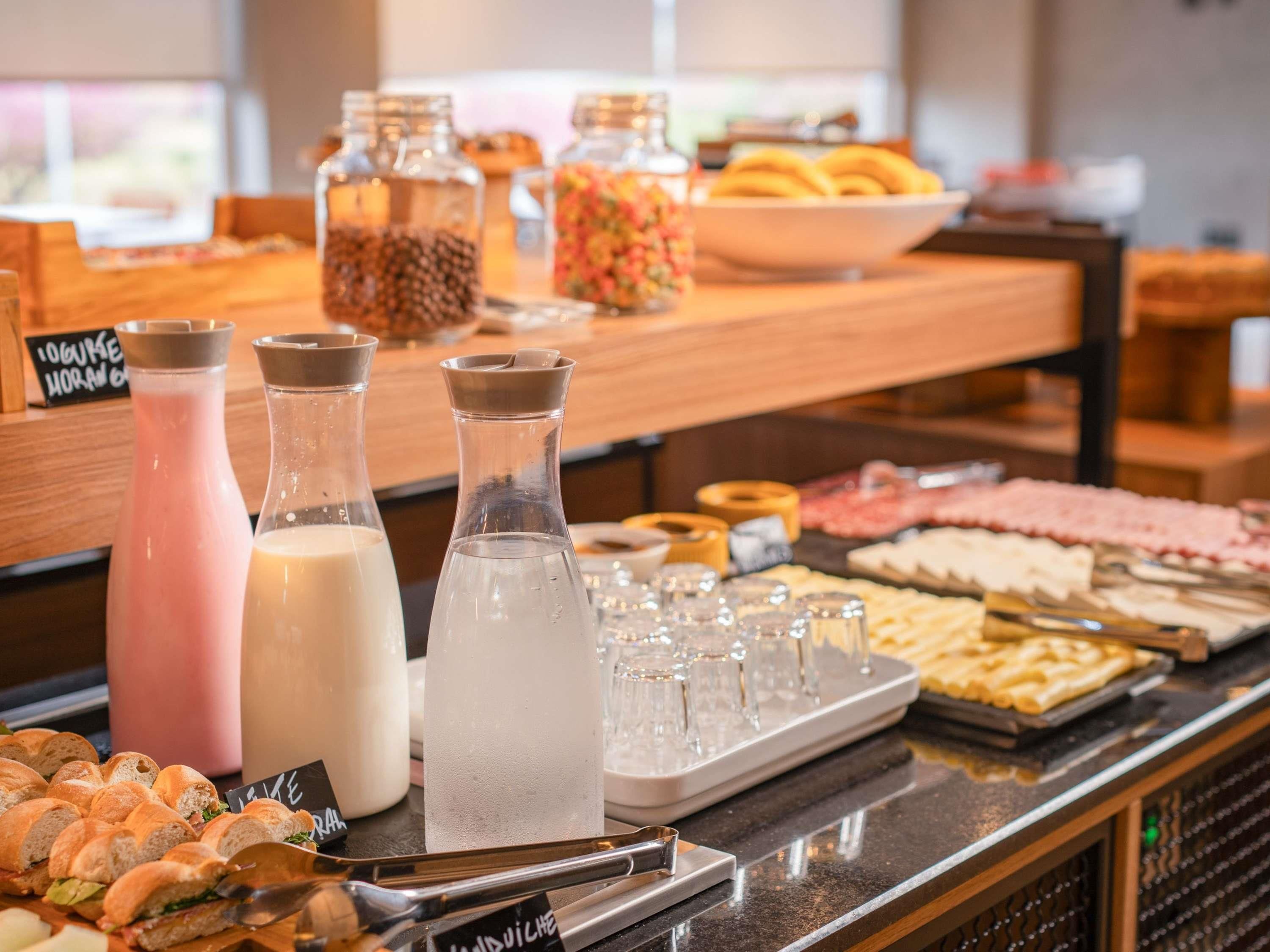A buffet with various food items and beverages.