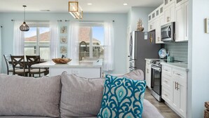 A modern kitchen with white cabinets, a built-in oven, and a microwave. - SUNRISE PARADISE - great view and close to the beach! (Crystal Beach)