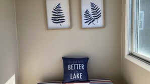 A bedroom with a bed, a window, and two framed leaf prints on the wall. - Beautiful Home in Ontonagon - 2 blocks from Lake Superior (Ontonagon)