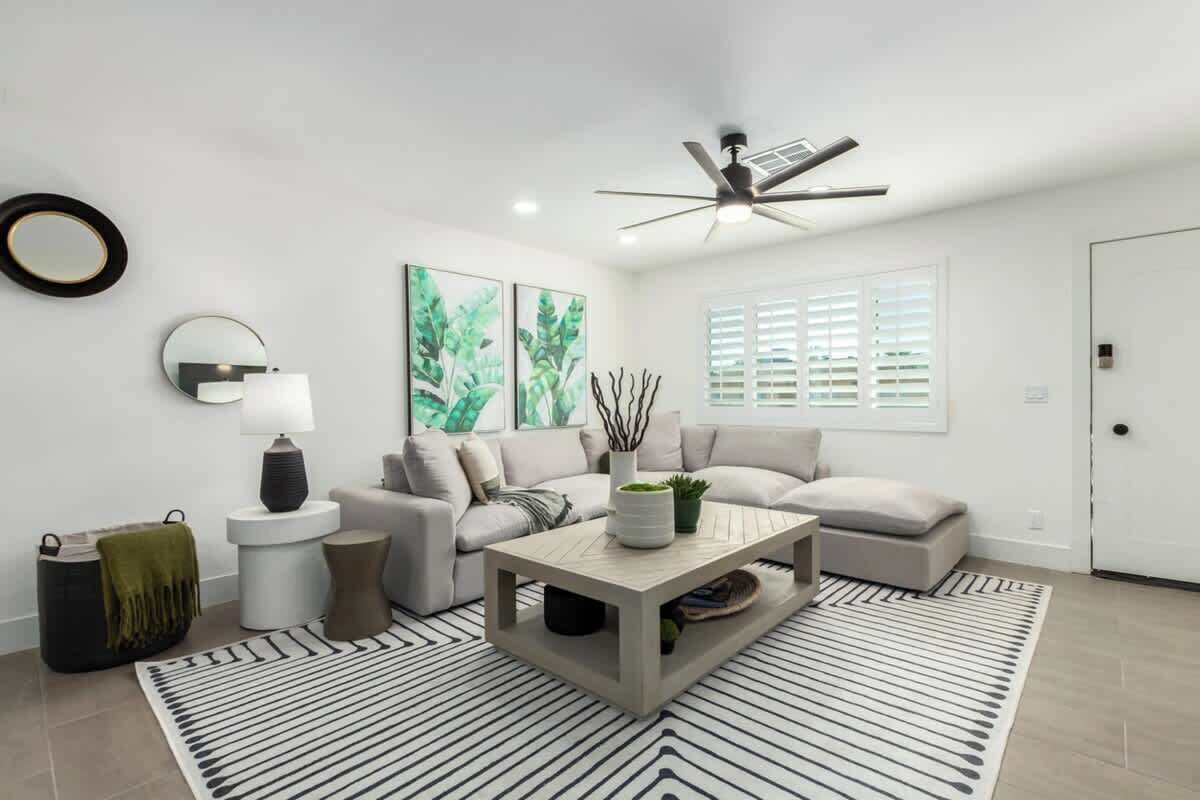 A modern living room with a sofa, coffee table, and decorative items.