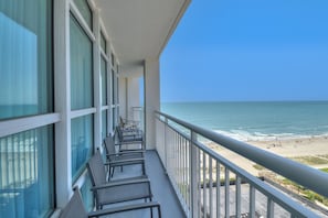 Enjoy breathtaking ocean views from this balcony with comfortable seating.