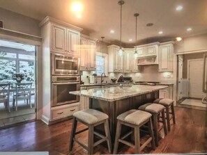 Enjoy cooking in this well-equipped kitchen with a central island and appliances.