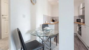 A modern kitchen with white cabinets, a microwave, and an oven. - Stylish 1BR Apt, Hunslet Leeds City Centre (Leeds)