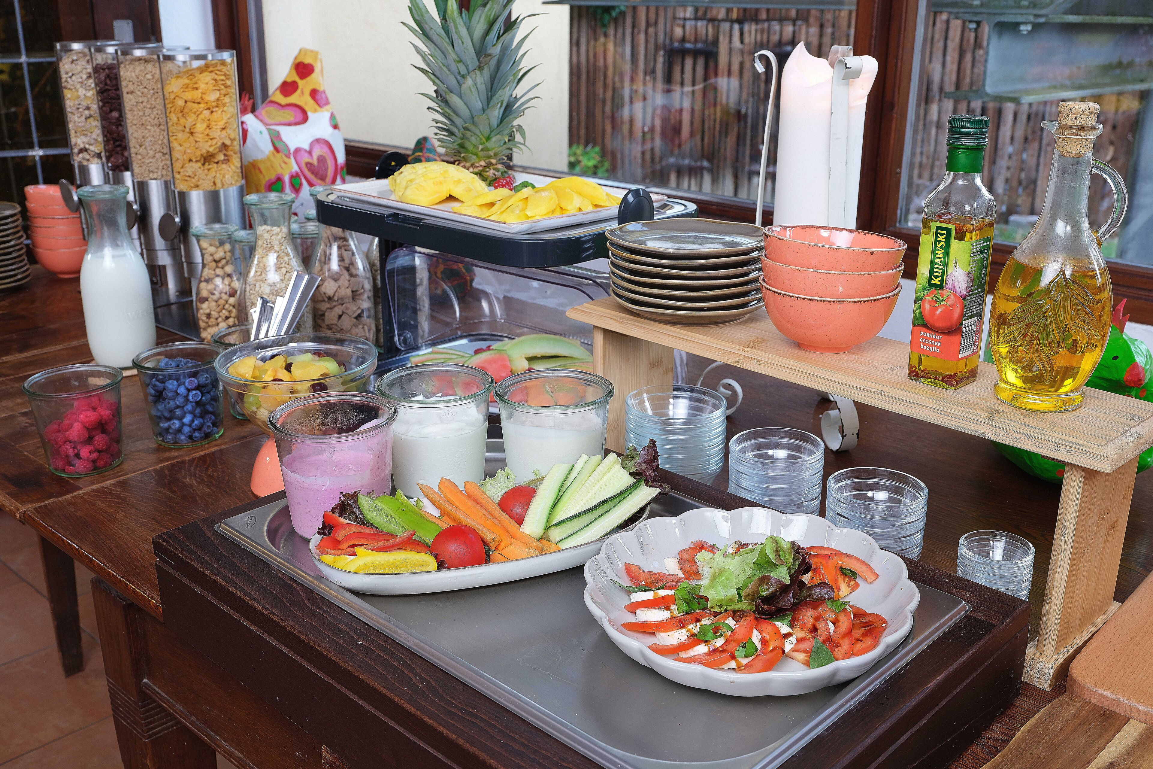 Ein reichhaltiges Frühstücksbuffet mit Obst, Gemüse und Getränken.