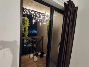 Enjoy the starry night sky from this balcony with a view, surrounded by twinkling string lights.