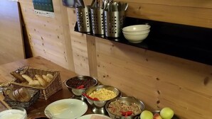 A buffet table with various food items including bread, meats, cheeses, fruits, and vegetables. - Cihlarka Mountain View Apartment (Cerny Dul)