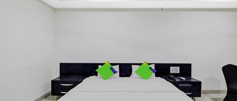 A bedroom with a bed, two nightstands, a chair, and a ceiling light fixture.