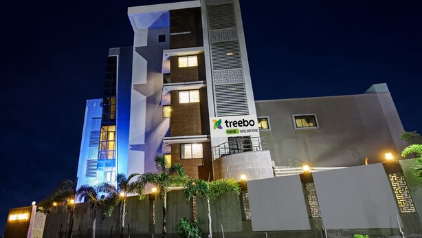 A modern hotel with a prominent vertical design, multiple windows, and a sign for 'treebo trend HOTEL BABY PEARL'. - Treebo Baby Pearl (Amravati)