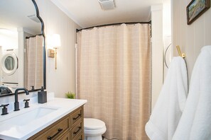 Combined shower/bathtub, towels, soap, toilet paper