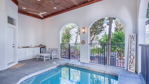 A pool area with a ceiling fan, a welcome sign, and a view of the outside. - 🐟Three Master Suites- Pet Friendly-Seas the Day on 30A (Santa Rosa Beach)