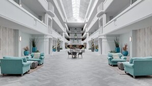 A spacious atrium with a high ceiling and a central open area.