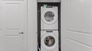 A compact laundry room with two stacked Whirlpool washers.