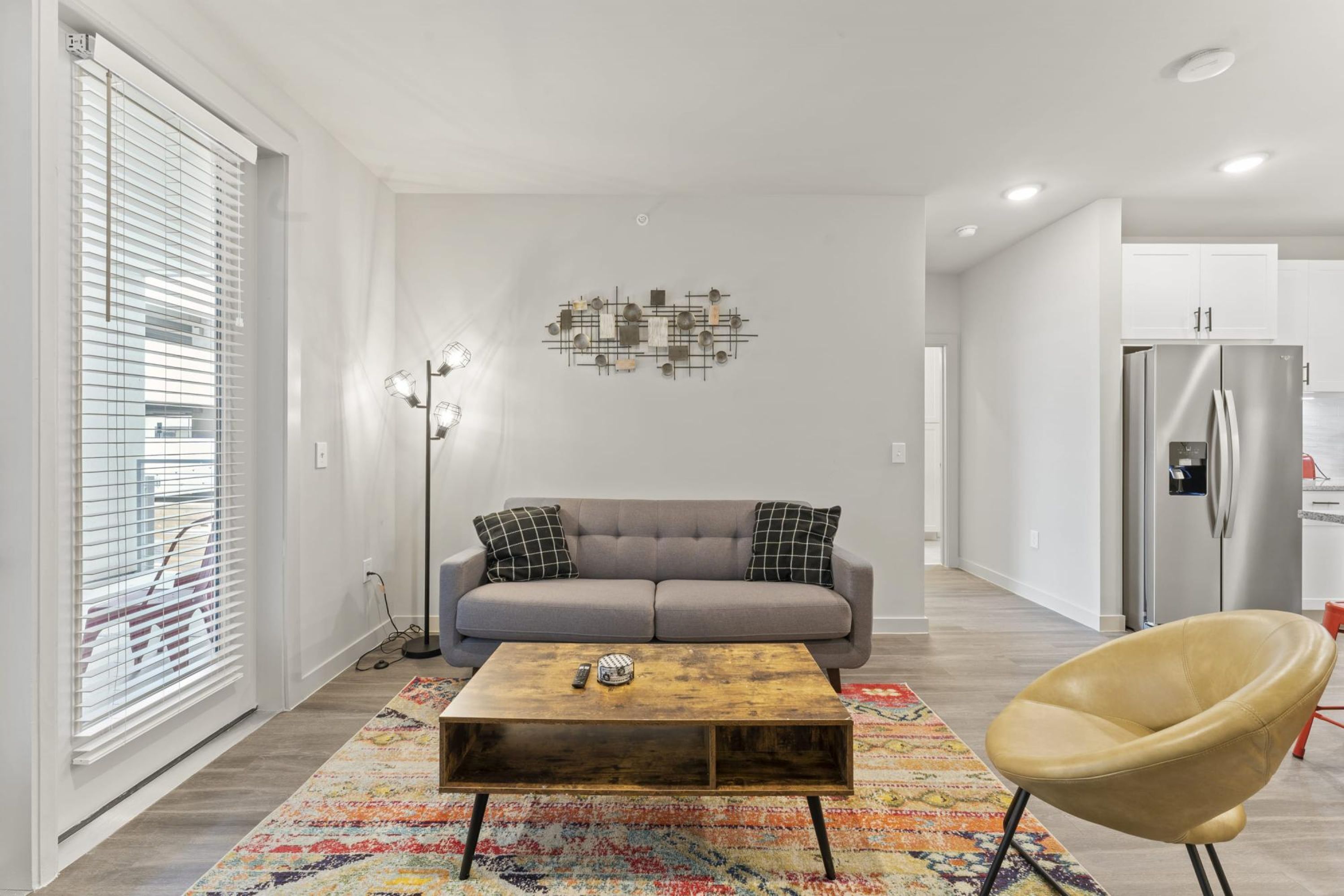 A modern living room with a sofa, coffee table, and a chair.