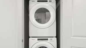 Two stacked Whirlpool washing machines in a narrow space. - Prime Soco Cozy 1BR King Suite w Pool Parking (Austin)