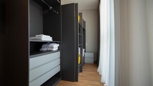 A walk-in closet with open doors, shelves, and drawers. - Old City Boutique Hotel (Tbilisi)