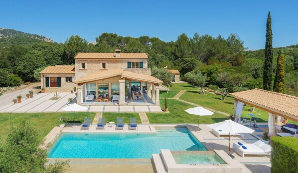 A two-story house with a swimming pool, outdoor seating, and a garden. - Luxurious Villa Golf Marina near Pollensa and Puerto Pollensa (Pollensa)