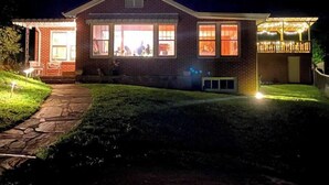 A house with a brick exterior, large windows, and a covered porch area. - Awesome House in Downtown Sylva! (Sylva)