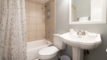 Combined shower/bathtub, towels, toilet paper