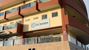 A multi-story building with balconies, a sign reading "Las Gaviotas," and a brick facade. - Hogar Dorado Las Gaviotas (Puerto Colombia)