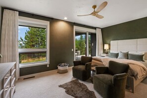 A bedroom with a bed, two chairs, a nightstand, a lamp, and a ceiling fan. - Ski-In/Ski-Out 3 Bedroom Moonlight Basin (Big Sky)