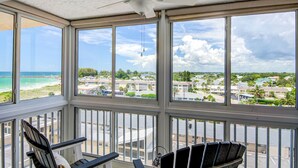 Un balcon avec vue sur la plage et un quartier résidentiel.