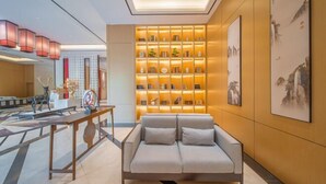 A modern living room with a sofa, a coffee table, and a bookshelf.