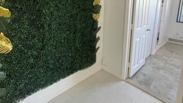 A hallway with a green wall covered in foliage and a 'Welcome' sign. - Luxurious NYC Retreat / Central Location / Wi-Fi (Freeport)
