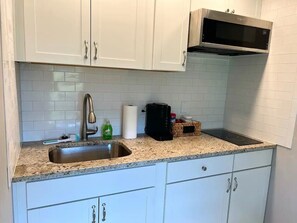 Fridge, microwave, stovetop, coffee/tea maker