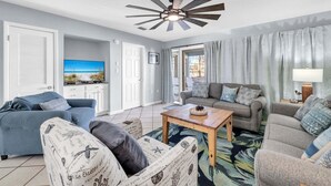 A living room with a ceiling fan, two sofas, a coffee table, and a television. - Beach Service Included, Pet Friendly! Pickle Ball Courts , CLM 11A! (Destin)