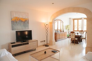 Relax in this stylish living room with a flat-screen TV, coffee table, and comfortable seating area.