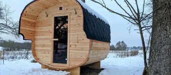 Vacation apartment in a cozy farmhouse by the bathing lake with large garden and sauna