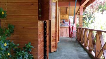 Step into this cozy cabin with a covered porch featuring a natural floor and a welcoming entrance mat.