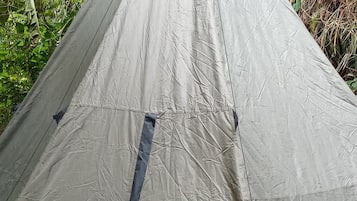 A tent with a peaked roof, a central entrance, and a ground entrance.