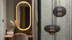 A modern bathroom with a vanity, a mirror with a light, and three hanging wicker lamps. -  Goose Living Bangkok BTS Phra Khanong (Bangkok)