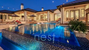 A modern house with a swimming pool, outdoor seating, and string lights. - ***NEW*** POOL | HOT TUB | POOL TABLE | Fire Pit | 16 Queen Beds (Austin)