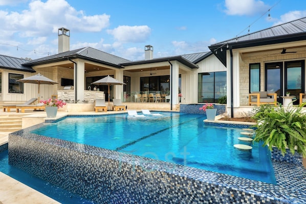 A heated pool, sun loungers
