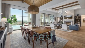 A spacious living area with a dining table, sofas, and a fireplace. - ***NEW*** POOL | HOT TUB | POOL TABLE | Fire Pit | 16 Queen Beds (Austin)