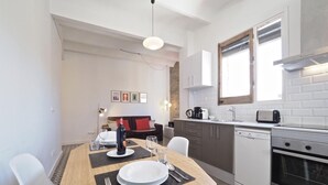 Eine moderne Küche mit weißen Schränken, einem eingebauten Backofen und einem Fenster über der Spüle.