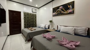 A hotel room with two beds, a painting, a door, and a curtain. - Julz El Nido Inn by Cocotel (El Nido)