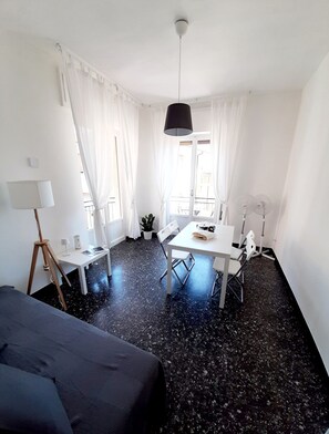Relax in a serene space with a large bed, desk, and dining area.