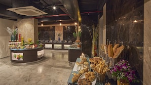 A buffet area with various food items and a marble floor. - Regenta Central Imperial Candolim Goa (Candolim)