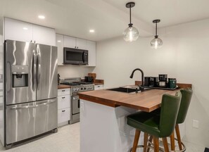 Fridge, coffee/tea maker, toaster, cookware/dishes/utensils