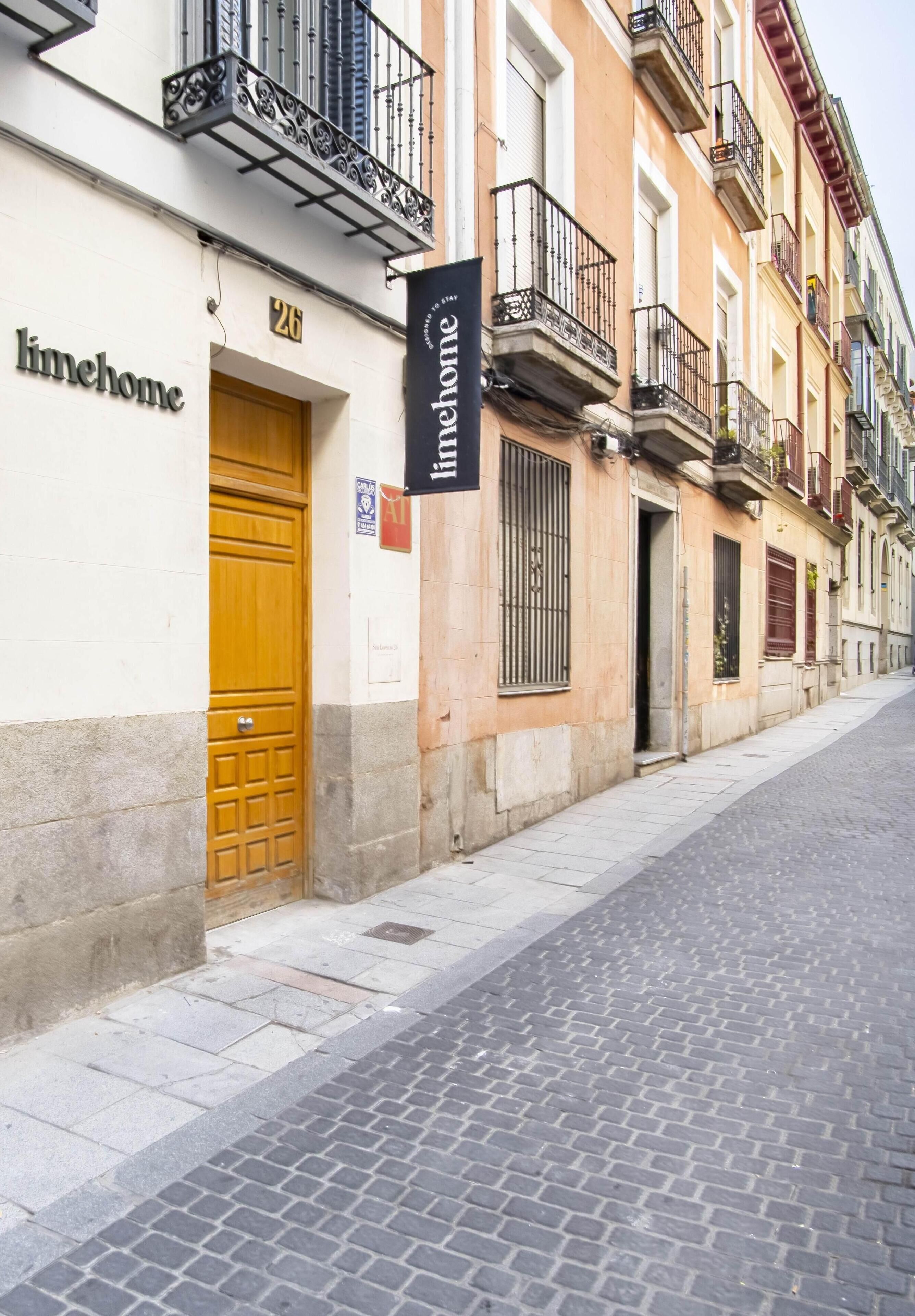 A building with a sign reading "linehome" and a number "26" above a wooden door.
