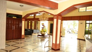 A spacious lobby with a checkered floor, a chandelier, and a large potted plant. - Morena Hotel Dodoma (Dodoma)