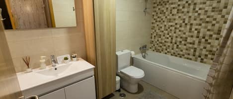 Bathtub, hair dryer, towels